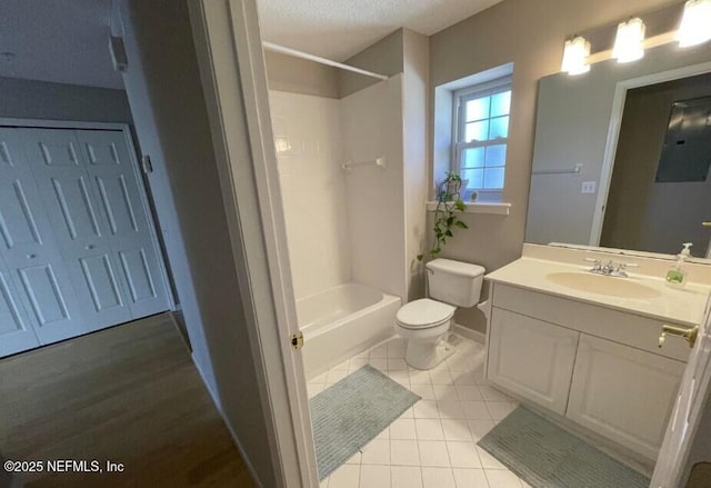 full bathroom with bathing tub / shower combination, tile patterned flooring, vanity, a textured ceiling, and toilet