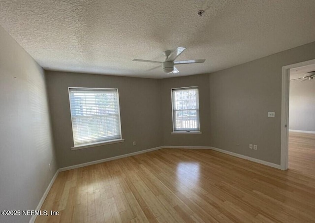 empty room featuring ceiling fan, light hardwood / wood-style floors, and a textured ceiling