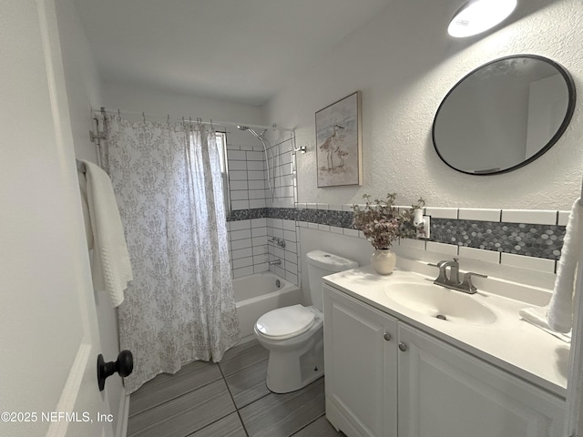 full bathroom featuring shower / tub combo with curtain, vanity, toilet, and backsplash