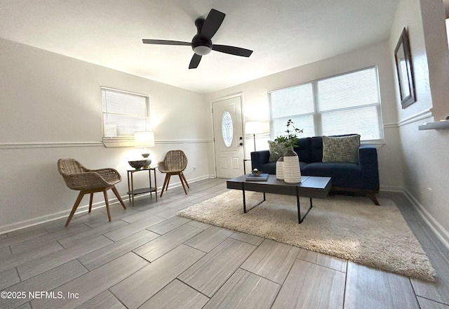 living room with ceiling fan and a healthy amount of sunlight