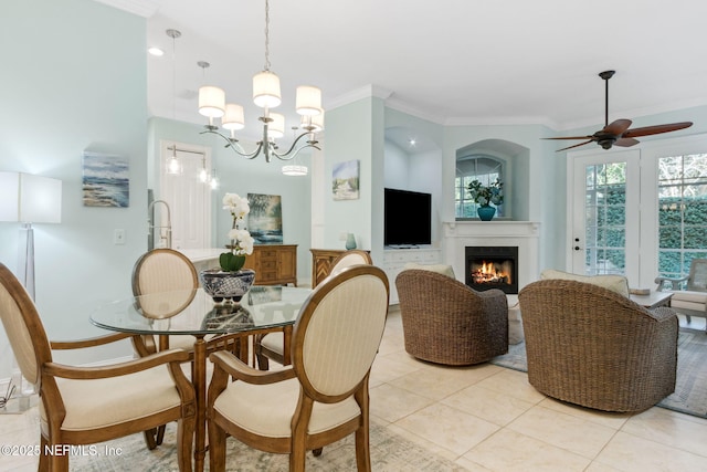 dining space with light tile patterned floors, a lit fireplace, and ornamental molding