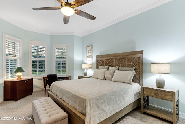 carpeted bedroom with crown molding, baseboards, and ceiling fan