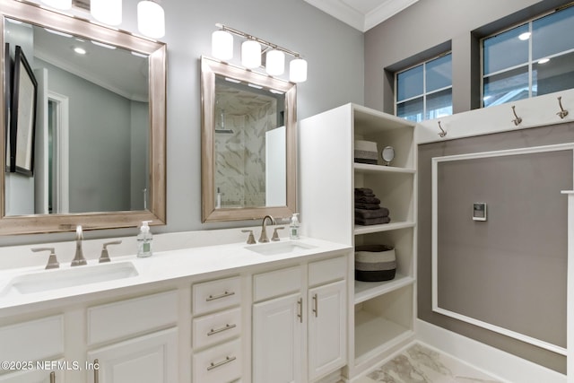 full bath with marble finish floor, crown molding, walk in shower, and a sink