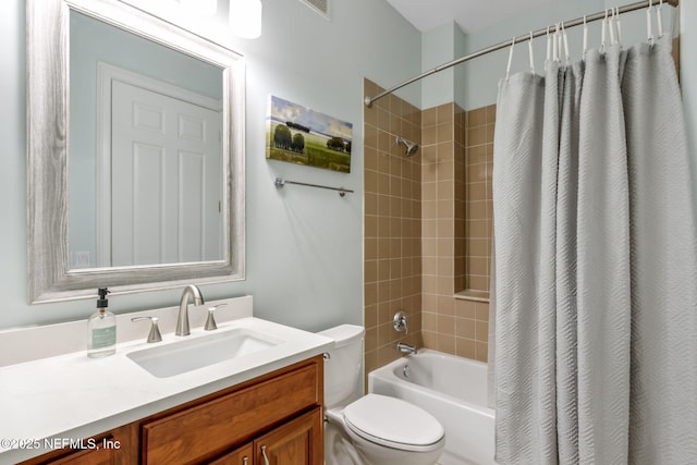 bathroom with vanity, shower / tub combo, and toilet