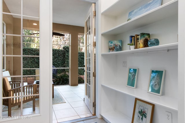 doorway featuring tile patterned floors and plenty of natural light