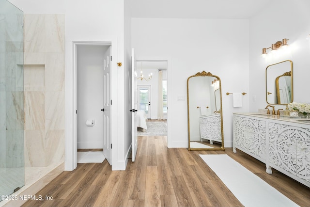 bathroom featuring vanity, tiled shower, and hardwood / wood-style floors