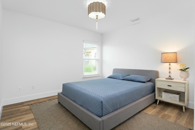 bedroom with dark wood-type flooring