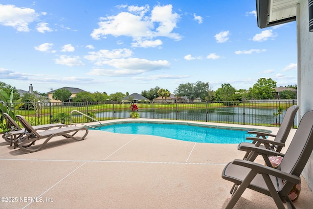 view of swimming pool with a water view and a patio area