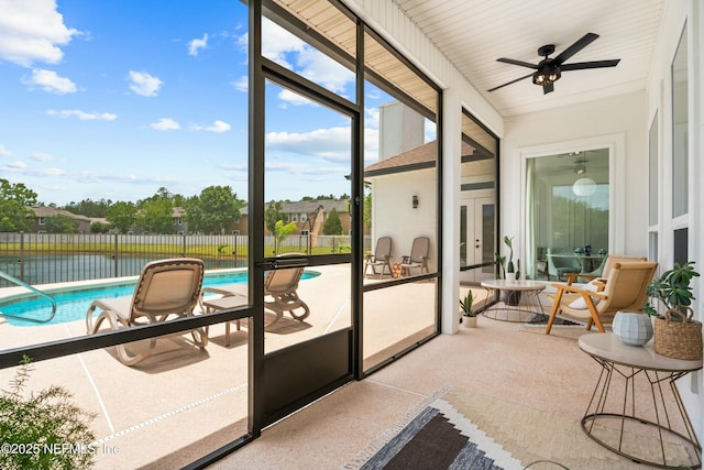 sunroom featuring ceiling fan