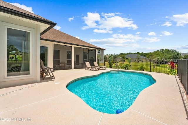 view of pool with a patio area and a sunroom