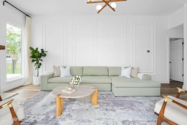 living room featuring a wealth of natural light and light hardwood / wood-style flooring