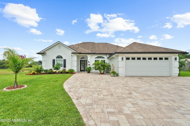 view of front of house with a garage and a front yard