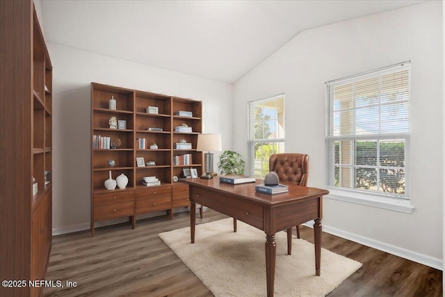 office area featuring dark wood-type flooring, lofted ceiling, and a wealth of natural light