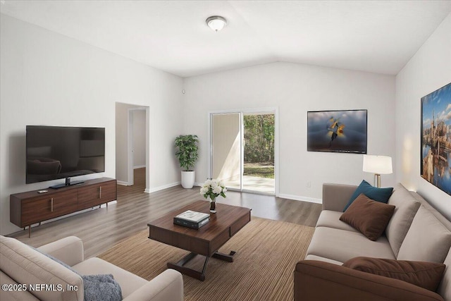 living room with vaulted ceiling and hardwood / wood-style floors