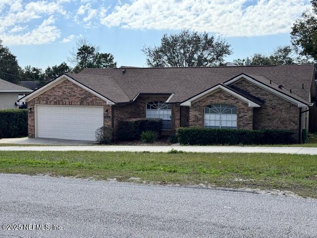 single story home featuring a garage