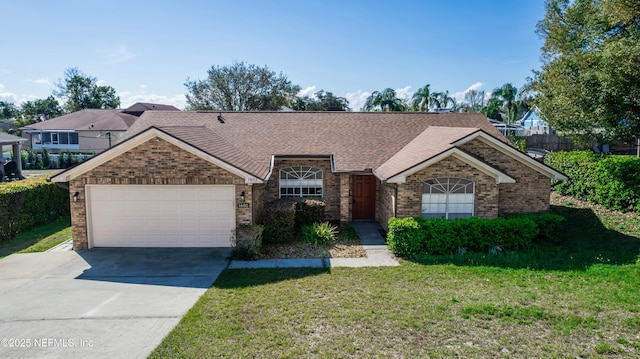 ranch-style home with brick siding, a shingled roof, an attached garage, driveway, and a front lawn