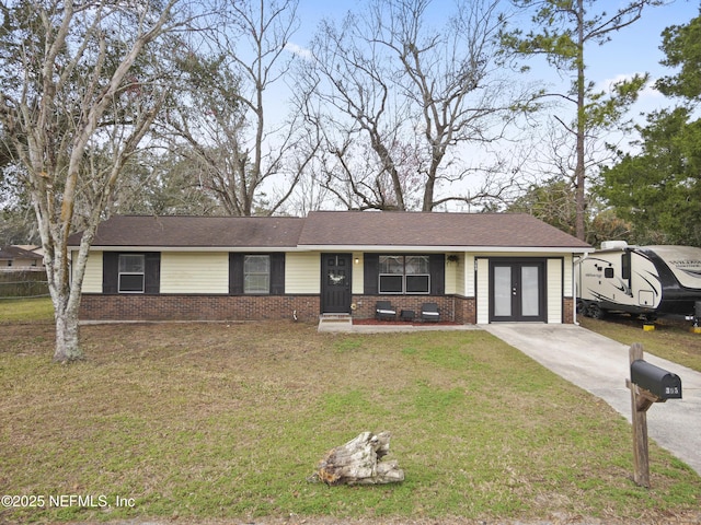 ranch-style home featuring french doors and a front lawn