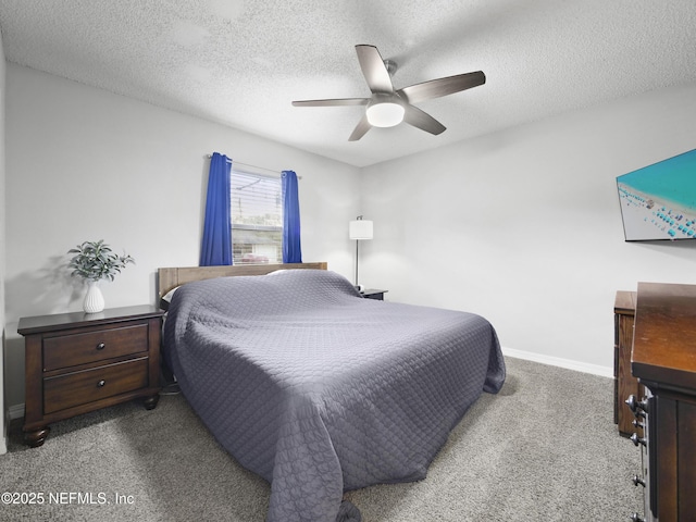 carpeted bedroom featuring ceiling fan and a textured ceiling