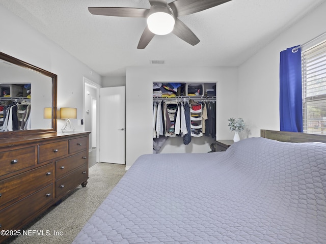 bedroom featuring ceiling fan, a textured ceiling, and a closet