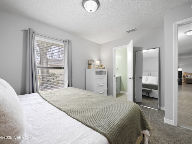 bedroom with carpet and a textured ceiling