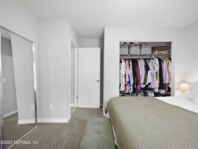 bedroom with a closet, a textured ceiling, and carpet flooring