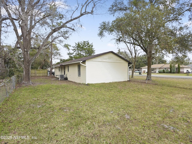 view of home's exterior with cooling unit and a yard