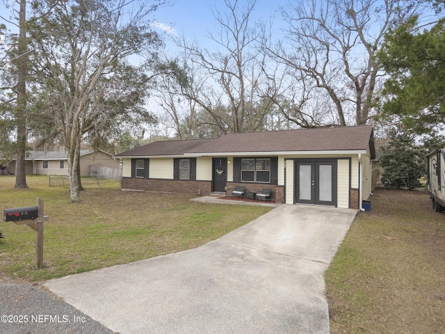 view of front facade with french doors and a front lawn