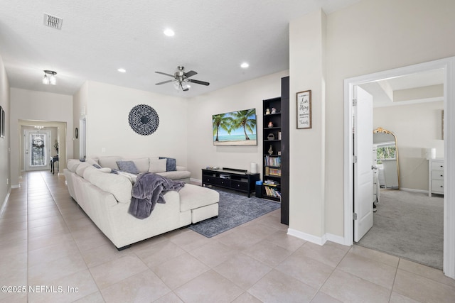 living room with light tile patterned floors, baseboards, visible vents, and recessed lighting