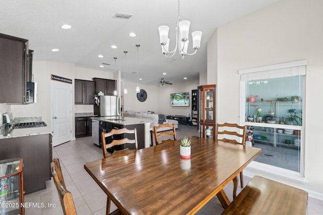 dining room with light tile patterned flooring, recessed lighting, visible vents, and ceiling fan with notable chandelier