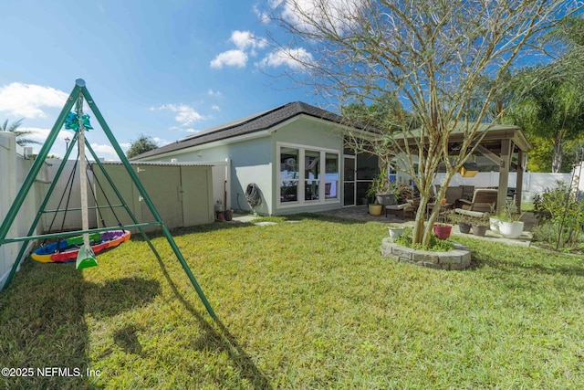 back of property featuring a fenced backyard, a lawn, and stucco siding