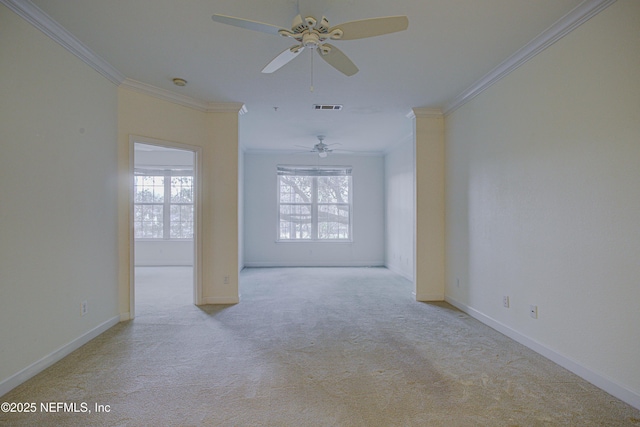 empty room featuring crown molding and light carpet