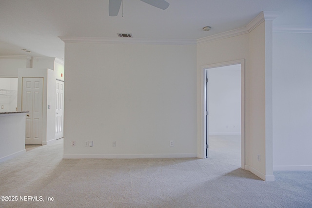 carpeted empty room featuring ornamental molding and ceiling fan