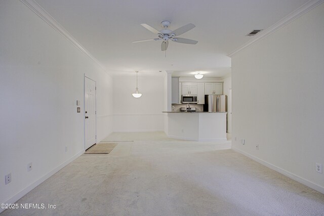 unfurnished living room featuring ornamental molding, light carpet, and ceiling fan