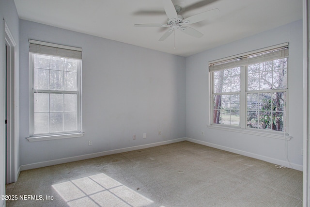 spare room with light carpet and ceiling fan