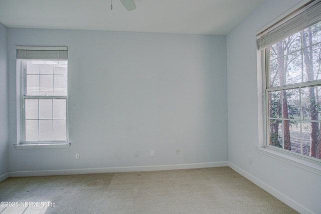 carpeted spare room with ceiling fan