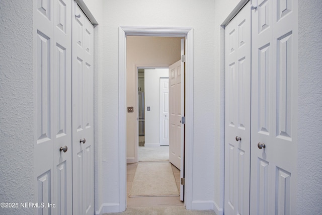 hall with light tile patterned floors