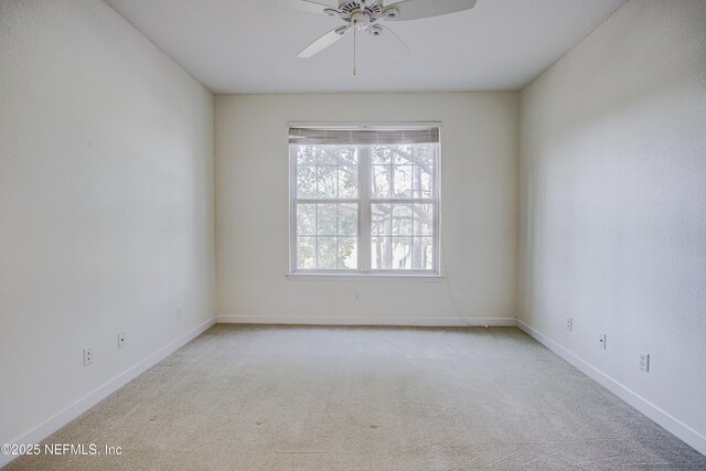 carpeted spare room with ceiling fan