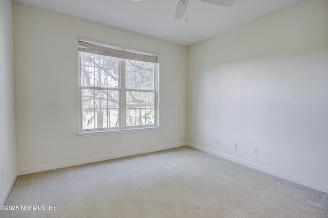 carpeted empty room featuring ceiling fan