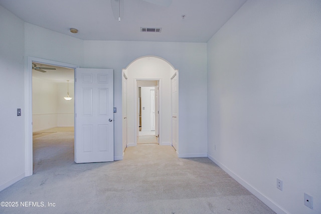 carpeted spare room with ceiling fan