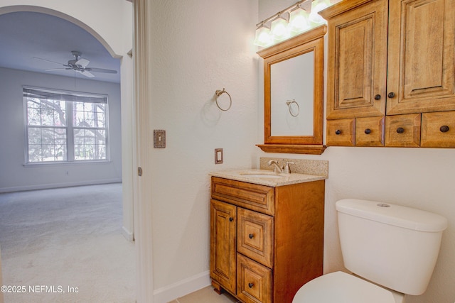 bathroom with ceiling fan, vanity, and toilet