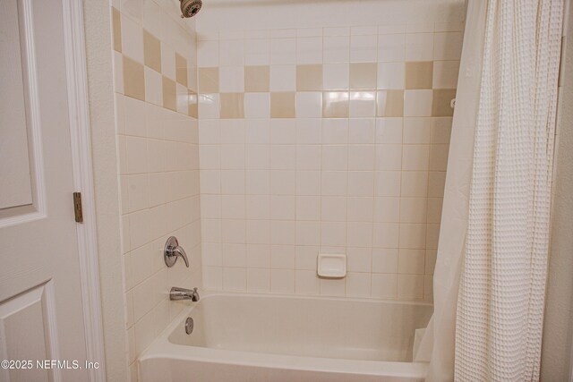 bathroom with shower / bathtub combination with curtain