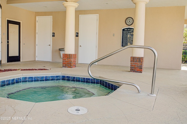 view of pool with a patio area and an indoor hot tub