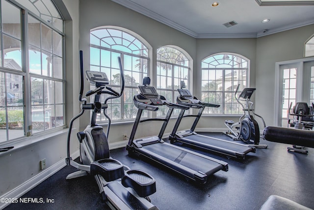 workout area featuring crown molding