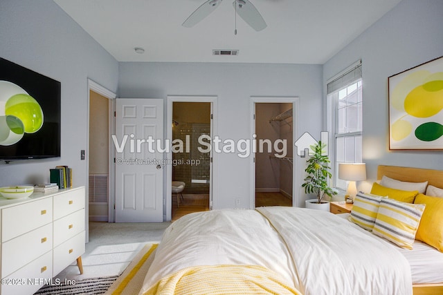 carpeted bedroom featuring ceiling fan and ensuite bath