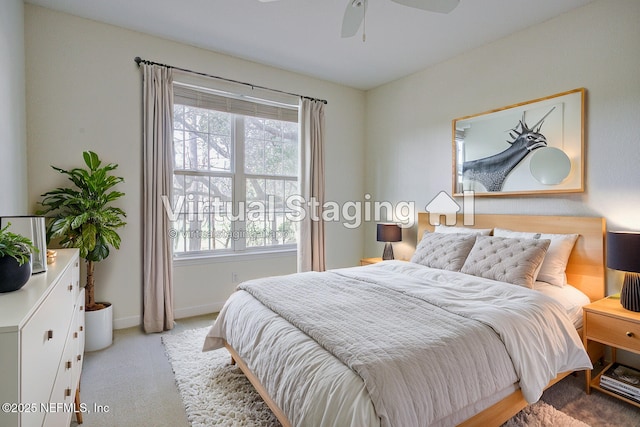 bedroom featuring ceiling fan, multiple windows, and light carpet