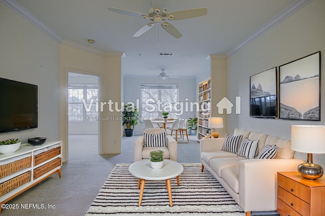 living room with crown molding, light colored carpet, and ceiling fan