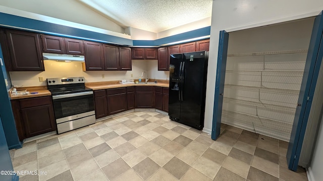 kitchen featuring sink, black fridge, vaulted ceiling, stainless steel electric range, and a textured ceiling