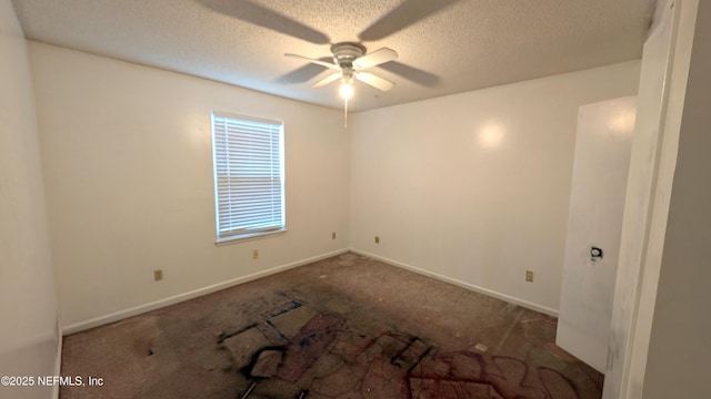 carpeted empty room featuring ceiling fan and a textured ceiling