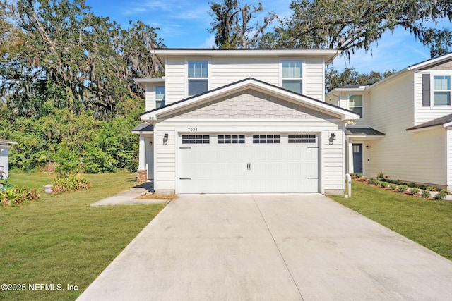 view of property with a garage and a front yard