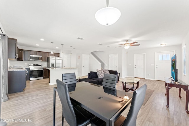 dining room featuring ceiling fan and light hardwood / wood-style floors